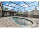 Gorgeous pool with screened-in enclosure and patio creating a tranquil outdoor oasis for relaxation and entertaining at 14190 Dove Hollow Dr, Orlando, FL 32824