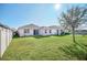 Large backyard, grassy area, home view at 144 Trinity Ridge Cir, Davenport, FL 33897