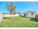 Backyard with grassy lawn and a tree at 144 Trinity Ridge Cir, Davenport, FL 33897