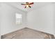 Well-lit bedroom with neutral carpet and ceiling fan at 144 Trinity Ridge Cir, Davenport, FL 33897