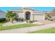 Curb appeal with a two-car garage and well-maintained lawn at 144 Trinity Ridge Cir, Davenport, FL 33897