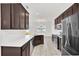 Modern kitchen with dark cabinets, stainless steel appliances, and an island at 144 Trinity Ridge Cir, Davenport, FL 33897