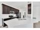 Modern kitchen with dark cabinetry, stainless steel appliances, and a large island at 144 Trinity Ridge Cir, Davenport, FL 33897