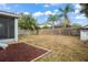 Large backyard with wooden fence, playground, and screened patio at 15208 Stonebriar Way, Orlando, FL 32826