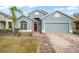 Curb appeal abounds at this charming one-story home, featuring a two-car garage and well-manicured landscaping at 15208 Stonebriar Way, Orlando, FL 32826