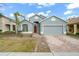 Two-story house with red door and paver driveway at 15208 Stonebriar Way, Orlando, FL 32826