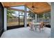 Screened porch with ceiling fan and table at 15208 Stonebriar Way, Orlando, FL 32826