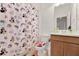 Clean bathroom with a Minnie Mouse themed shower curtain and wood cabinets at 1593 Osprey View Dr, Apopka, FL 32703