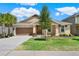 Attractive single-story home with a landscaped lawn and two-car garage at 1593 Osprey View Dr, Apopka, FL 32703