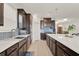 Modern kitchen with dark cabinets, a large island, and stylish backsplash at 1593 Osprey View Dr, Apopka, FL 32703