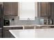 Modern kitchen features stainless steel appliances and white quartz countertops at 1593 Osprey View Dr, Apopka, FL 32703