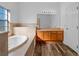 Bathroom featuring a vanity, garden tub, and tile flooring at 18433 Reynolds Pkwy, Orlando, FL 32833