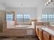 Main bathroom with double vanity, garden tub, and tile flooring at 18433 Reynolds Pkwy, Orlando, FL 32833