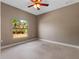 Spacious bedroom with large window offering natural light and ceiling fan at 18433 Reynolds Pkwy, Orlando, FL 32833