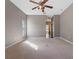 Primary bedroom with carpet, ceiling fan and access to the bathroom at 18433 Reynolds Pkwy, Orlando, FL 32833