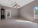 Large bedroom with neutral walls, carpet flooring, and a ceiling fan at 18433 Reynolds Pkwy, Orlando, FL 32833