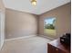 Well-lit bedroom with a large window, neutral walls, and carpeted floor at 18433 Reynolds Pkwy, Orlando, FL 32833