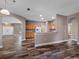 Open dining area with wood-look tile floors and views of the kitchen and entryway at 18433 Reynolds Pkwy, Orlando, FL 32833