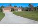 One-story home with a two-car garage and a spacious lawn at 18433 Reynolds Pkwy, Orlando, FL 32833