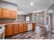 Kitchen with wood cabinets, tile flooring, and a view into the adjacent dining area at 18433 Reynolds Pkwy, Orlando, FL 32833