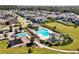 Aerial view of community pool, playground, and surrounding homes at 1873 Donahue Dr, Ocoee, FL 34761