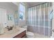 Clean bathroom with shower/tub combo and striped curtain at 1873 Donahue Dr, Ocoee, FL 34761