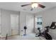 Bright bedroom with window, ceiling fan, and exercise bike at 1873 Donahue Dr, Ocoee, FL 34761