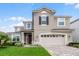 Two-story home with a neutral color scheme and landscaped yard at 1873 Donahue Dr, Ocoee, FL 34761