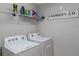 Laundry room with washer, dryer, and shelving at 1873 Donahue Dr, Ocoee, FL 34761