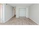 Simple bedroom with wood-look floors and a large closet at 2230 Cascades Blvd # 207, Kissimmee, FL 34741