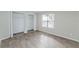 Spacious bedroom featuring wood-look floors and a large closet at 2230 Cascades Blvd # 207, Kissimmee, FL 34741