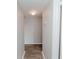 Simple hallway with light gray walls and wood-look floors at 2230 Cascades Blvd # 207, Kissimmee, FL 34741