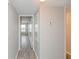 Simple hallway with neutral colored walls and laminate flooring at 2230 Cascades Blvd # 207, Kissimmee, FL 34741