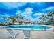 Relaxing community pool area with lounge chairs at 2230 Cascades Blvd # 207, Kissimmee, FL 34741