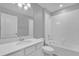 Bathroom boasts a bathtub, vanity with white cabinets, and a mirror at 232 Rustic Loop, Sanford, FL 32771