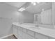 Double vanity bathroom with white cabinets and large mirror at 232 Rustic Loop, Sanford, FL 32771