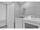 Laundry room with washer, dryer, and shelving at 232 Rustic Loop, Sanford, FL 32771