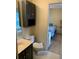 Bathroom with a cabinet above the toilet and an adjoining bedroom at 252 Wimbledon Cir # 1702, Lake Mary, FL 32746