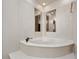 Round bathtub with decorative wall detail in this bathroom at 252 Wimbledon Cir # 1702, Lake Mary, FL 32746