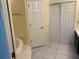 Bright bathroom featuring a soaking tub, closet, neutral tile flooring, and a separate toilet room at 252 Wimbledon Cir # 1702, Lake Mary, FL 32746