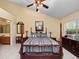 Spacious main bedroom with wood poster bed and ensuite bath at 252 Wimbledon Cir # 1702, Lake Mary, FL 32746