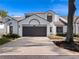 Two-story home with white exterior, dark garage door, and landscaping at 252 Wimbledon Cir # 1702, Lake Mary, FL 32746