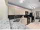 Modern kitchen with granite countertops and black appliances at 252 Wimbledon Cir # 1702, Lake Mary, FL 32746