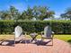 Brick patio with two adirondack chairs and small table at 252 Wimbledon Cir # 1702, Lake Mary, FL 32746