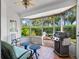 Sunroom with comfy seating, screened enclosure and grill at 252 Wimbledon Cir # 1702, Lake Mary, FL 32746