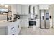 Modern kitchen with white shaker cabinets, quartz countertops, and stainless steel appliances at 2823 Boulder Falls Ct, Apopka, FL 32703