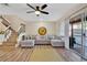 Spacious living room with L-shaped sofa, hardwood floors, and a ceiling fan at 2823 Boulder Falls Ct, Apopka, FL 32703