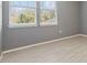 Grey bedroom with light wood laminate flooring at 284 Tuska Reserve Cv, Casselberry, FL 32707