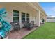 Relaxing covered patio with wicker furniture and a view of the backyard at 284 Tuska Reserve Cv, Casselberry, FL 32707