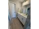 Stylish bathroom featuring double sinks and light wood floors at 3 Fisher Loop Crse, Ocklawaha, FL 32179